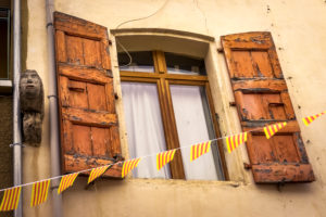 Window with old wooden shutters in Molitg les Bains Window with old wooden shutters in Molitg les Bains